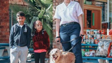 Callen Naidoo and Imani Pather stand alongside SPCA Randburg's Josephine Baxter as she holds onto Lily the Golden Retriever. Photo: Neo Phashe