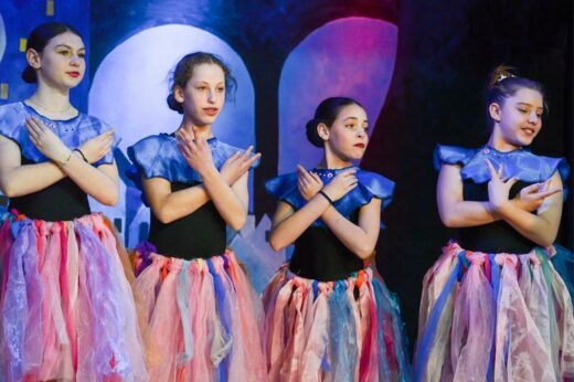 Mia Lissoos, Jordan Levin, Scarlet Feigin and Sasha Goldberg dance in one scene of King David Victory Park's production of Charlie and the Chocolate Factory.