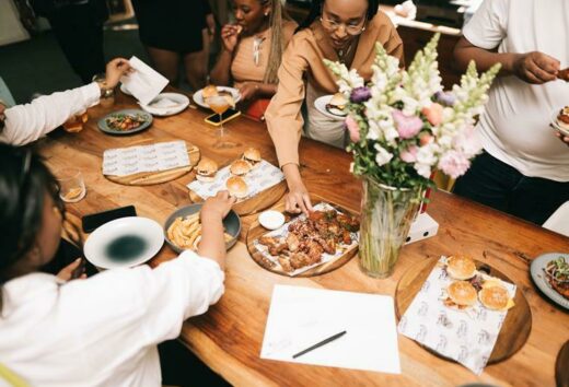 Guests enjoy some food at the opening of Studio Mukheli.