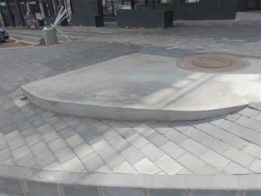 There is a service chamber below this concrete step. JDA are in the process of seeing if it can lowered. Should this not be viable, the paving will be raised up to prevent a tripping hazard.