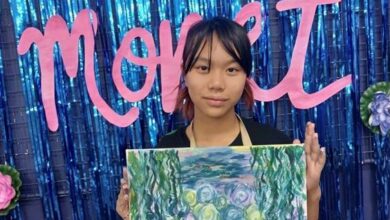 Angeli Xu shows off her painting.