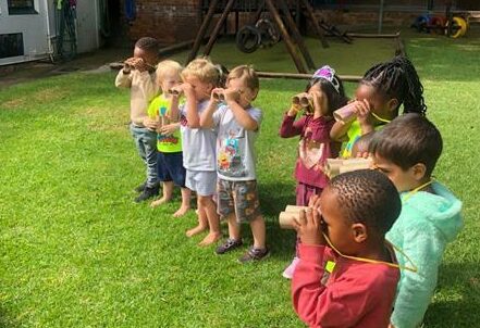 Children use their binoculars while on search for the next wild animal.