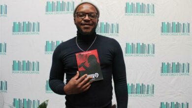 Kabelo Makeke wa Ncube holds his book, Taverning After 9.