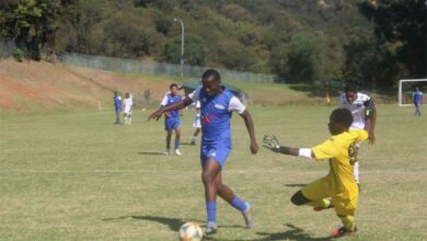 Tumelo Machisi (blue) battles with Wits Juniors goalkeeper Thembalethu Nkosi.