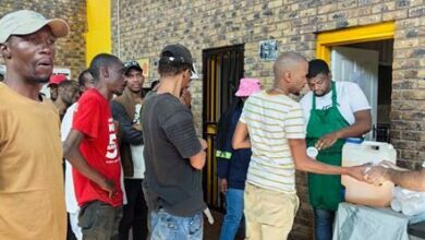 People queue to get food.