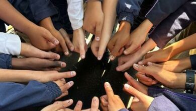 A collection of thumbs with blue stripes after the children had voted.