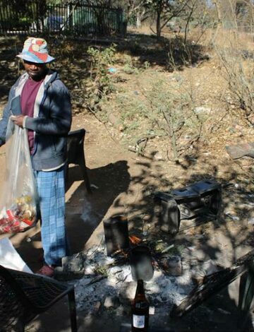 A resident collects cans for some money just to get by.