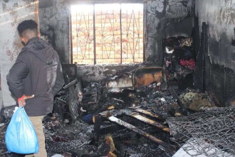 Residents rushed in with water buckets before firefighters arrived, helping contain a fire that damaged two rooms on Fulham Road.