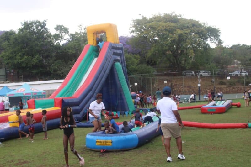 Despite the weather, families turned out in full force to experience the water slides, laughter, and enjoy local treats.