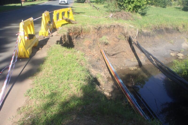 The entity has moved to secure a badly eroded road while plans are finalised to address a nearby stream blockage blamed for diverting water onto the road.