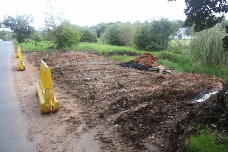A visit on April 1 shows the collapsed roadside has been filled in, with barricades still in place as longer-term repairs are still being completed.
