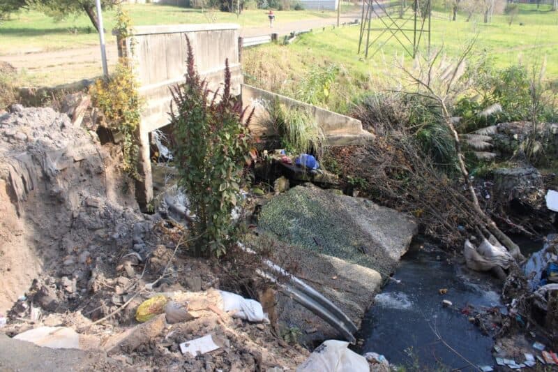 A blocked drainage system at a key Alberts Farm crossing raises fears of a potential road collapse and long-term disruption to surrounding communities.