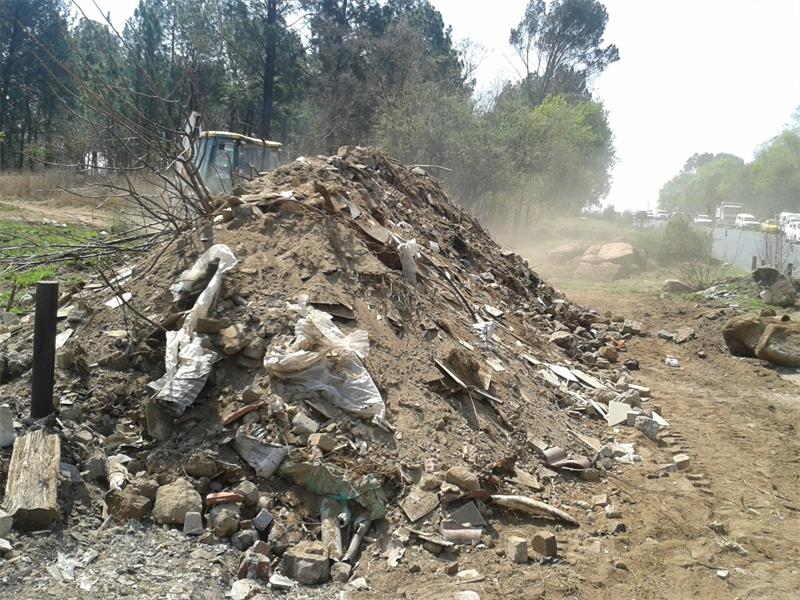 : A tractor-loader-backhoe clears rubble. Photo: Supplied