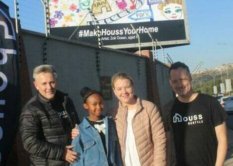 A nine-year-old's colourful depiction of friendship, play and community life has gone from a sheet of paper to a giant billboard — and she had no idea she was the winner until the unveiling.