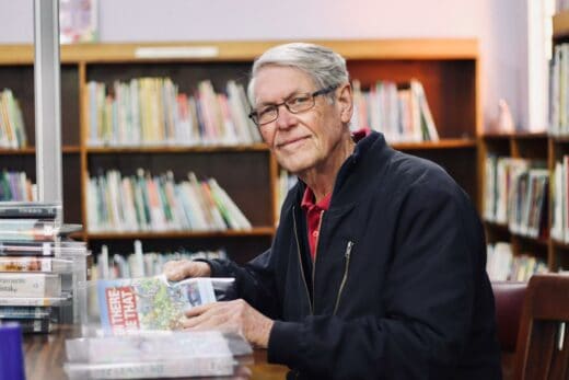 Alec Linde sits to help cover library books on July 7, 2026, at the Linden Library. Photo: Neo Phashe