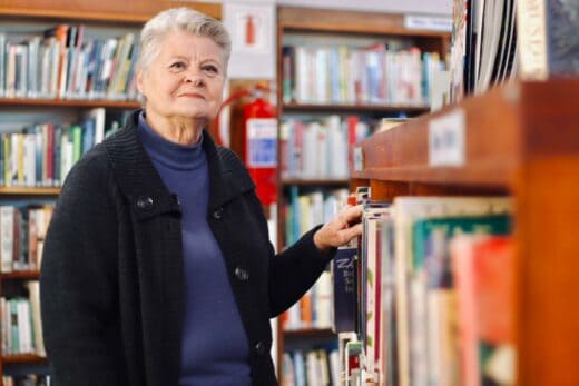 Maureen Freeman stands at one of the book shelves of Linden Library on July 7, 2026. Photo: Neo Phashe