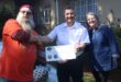 Cornell Grewar (left) and Sonja Hood (right) of Clearwater Chapter South Africa Harley Owners Group present a donation cheque to Darren Huke (middle) of Eventide Home for the Aged on July 18, 2026, in Emmarentia. Photo: Waydon Jacobs