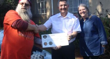 Cornell Grewar (left) and Sonja Hood (right) of Clearwater Chapter South Africa Harley Owners Group present a donation cheque to Darren Huke (middle) of Eventide Home for the Aged on July 18, 2026, in Emmarentia. Photo: Waydon Jacobs