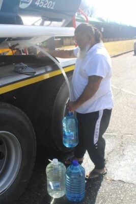 Roosevelt Park resident Jeevan Uren fills large water containers on July 19, 2026 at Gen Homes in Roosevelt Park. Photo: Waydon Jacobs