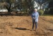 Fairland Estate resident Arlene Mania stands beside the stalled Fairland gabions project, where work has come to a halt despite earlier assurances that contractors would return. Photo: Waydon Jacobs