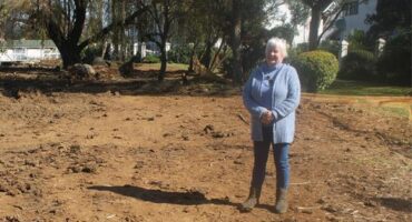 Fairland Estate resident Arlene Mania stands beside the stalled Fairland gabions project, where work has come to a halt despite earlier assurances that contractors would return. Photo: Waydon Jacobs