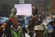 Mapitsi Civil Works contractor holds a piece of paper that reads, ‘3 months no payment’, for work on Hursthill 2 reservoir on August 7, 2026, following their protest at Johannesburg Water head offices in Newtown. Photo: Waydon Jacobs