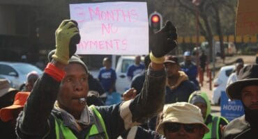 Mapitsi Civil Works contractor holds a piece of paper that reads, ‘3 months no payment’, for work on Hursthill 2 reservoir on August 7, 2026, following their protest at Johannesburg Water head offices in Newtown. Photo: Waydon Jacobs