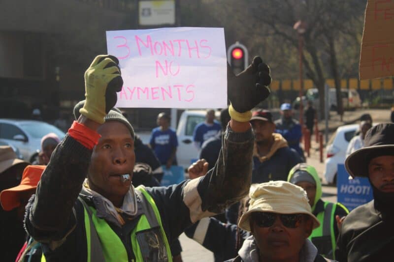 Mapitsi Civil Works contractor holds a piece of paper that reads, ‘3 months no payment’, for work on Hursthill 2 reservoir on August 7, 2026, following their protest at Johannesburg Water head offices in Newtown. Photo: Waydon Jacobs