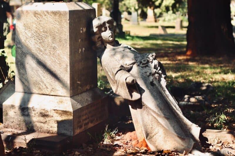 Community members rolled up their sleeves to clean graves and clear invasive vegetation while calling for greater protection of the historic cemetery.