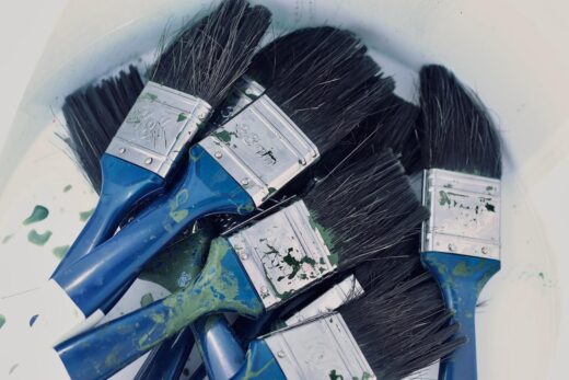 A bucket of paintbrushes ready to be used after a wash. Photo: Neo Phashe