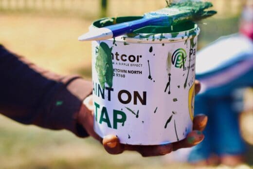 A bucket of the green paint used to paint the fence. Photo: Neo Phashe