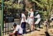 Community members happily paint the fence. Photo: Neo Phashe