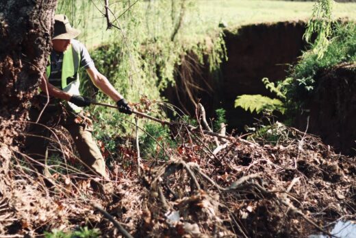André Swaenepoel pulls out fallen branches from the spruit on September 12, 2026 in Fairland. Photo Neo Phashe