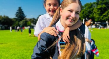 Morgan Dreyer carries a Grade 1 learner on her back on October 8, 2026 at De La Salle Holy Cross College. Photo: Neo Phashe