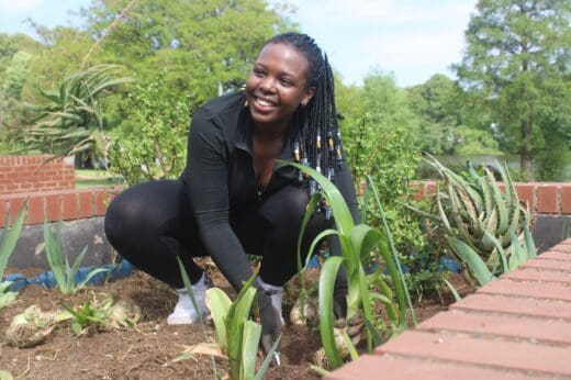 Thandiswa Masuku gets her hands dirty while planting at Westdene Dam during the ‘Mind Your Dam Business’ initiative on October 10, 2026, at the Westdene Dam. Photo: Waydon Jacobs