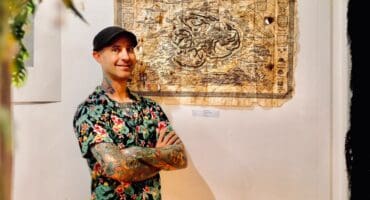 Busta Boltoon stands at one of his art pieces on October 18, 2026 at the Stokvel Gallery at 27 Boxes in Melville. Photo: Neo Phashe