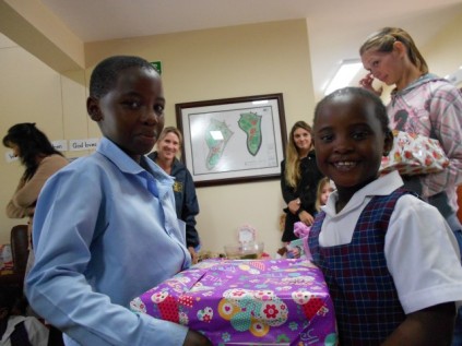 Grade one pupil Thandolwethu Mthembu (left), blesses a pupil from the Thembeni Primary School.