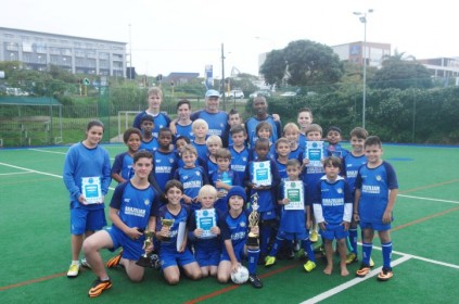 The BSS team with coach Peter Hooper showing off their silverware. 