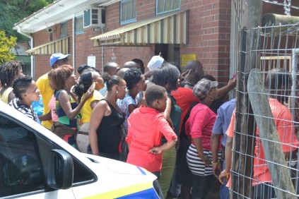 People looking through the fence to see 'Desperado'.