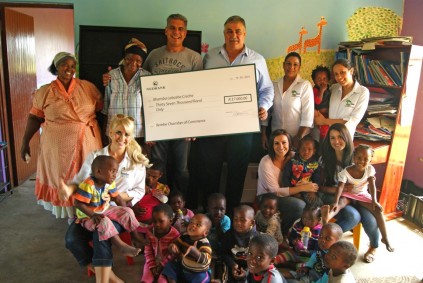 From left, creche mother Thandi Bhukazi, Ilembe Chamber’s Renalda Hoffman, creche mother Nomgqibelo Gwaai, Chamber CEO Cobus Oelofse, Ballito Street Heroes organiser Ed Hill, Soul Sister Charlene Phytides, TREE senior programmes manager Roseisha Ishwardutt, Soul Sister Samantha van Rensburg and TREE project co-ordinator Terry Kaas, along with some of the creche’s children.