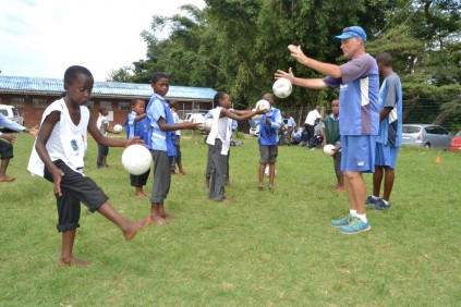 Peter Hooper guides the boys through a juggling drill.