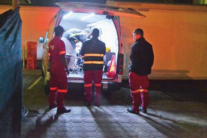 The light before the end of the tunnel. Paul Herbst and IPSS paramedics about to wheel a patient into Victoria Hospital.