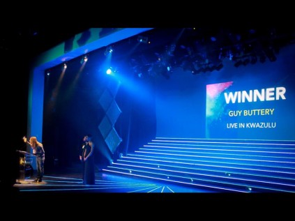 Guy Buttery receiving his award on stage.