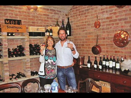 Christa White with winemaker Sebastian Beaumont in the White's wine cellar.
