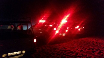 Off-road vehicles lining the beach to help provide light at night. Photo: IPSS Medical Rescue