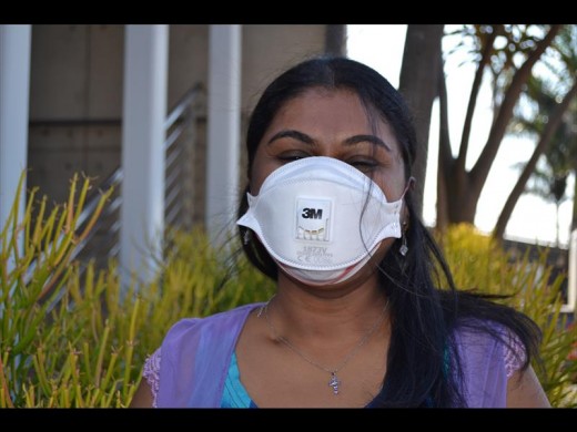 Laura Mosiah with the mask that she had to wear most of the time treating patients.
