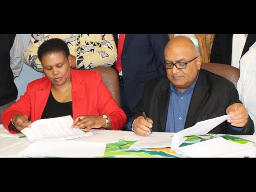 Chief Land Claims Commissioner Nomfundo Gobodo and SASA executive director Trix Trikam sign the MoU.