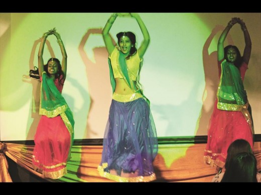 Student Ashvir Eraman throwing some traditional shapes on stage. ABOVE: Crawford students Revania Naidoo, Melanka Nurasiaha and Sayuri Chetty performing a traditional dance in their colourful saris.