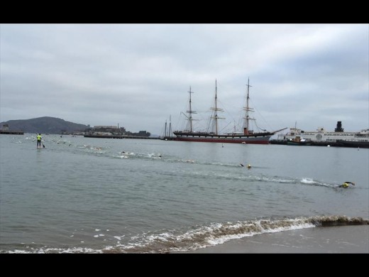 Strode (second place from shore) finishing the frigid swim across the San Francisco Bay from Alcatraz to the mainland.
