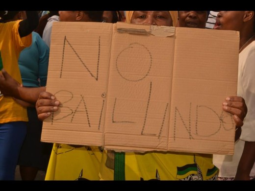 A resident holding up a cardboard with a clear message.